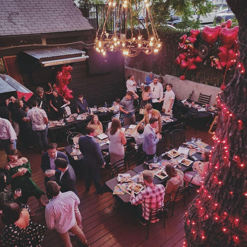 Group celebrating on the oak tree patio at Pelons Tex Mex in Austin